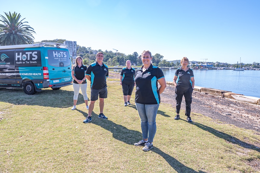 Five Health on the Streets staff, standing near van at the waterfront, 2022.