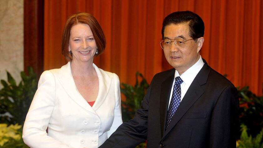 Australian Prime Minister Julia Gillard shakes hands with Chinese president Hu Jintao