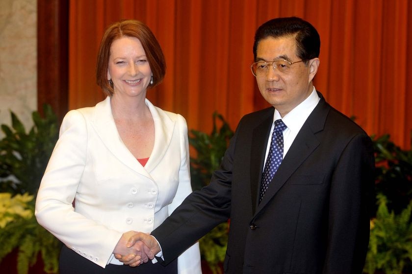 Australian Prime Minister Julia Gillard shakes hands with Chinese president Hu Jintao