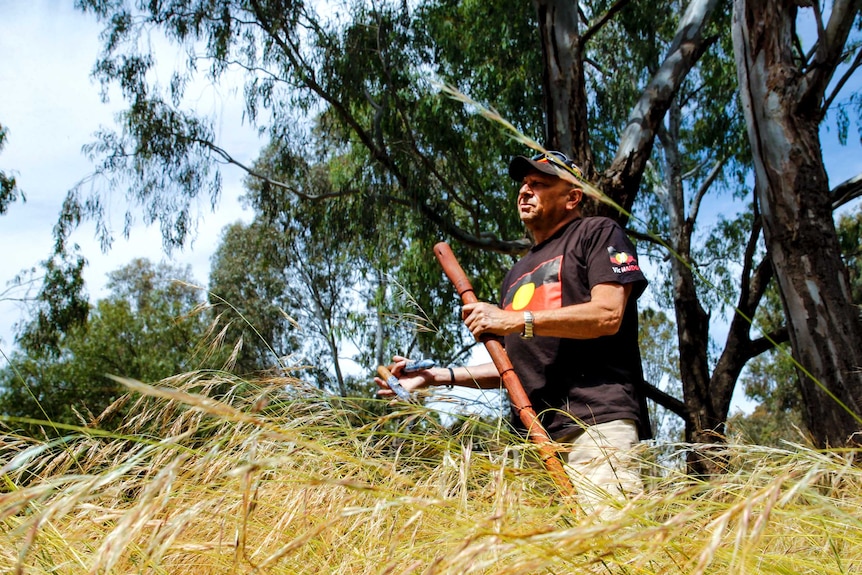 Aboriginal Indigenous elder Uncle Trevor Gallagher stands in Darebin Parklands in inner city Melbourne.