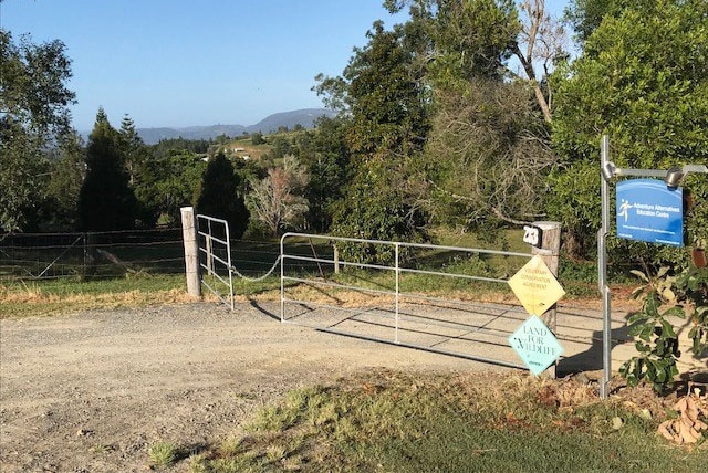 Gate entrance and signage to Adventure Alternatives Education Centre at Woodford on Queensland's Sunshine Coast.