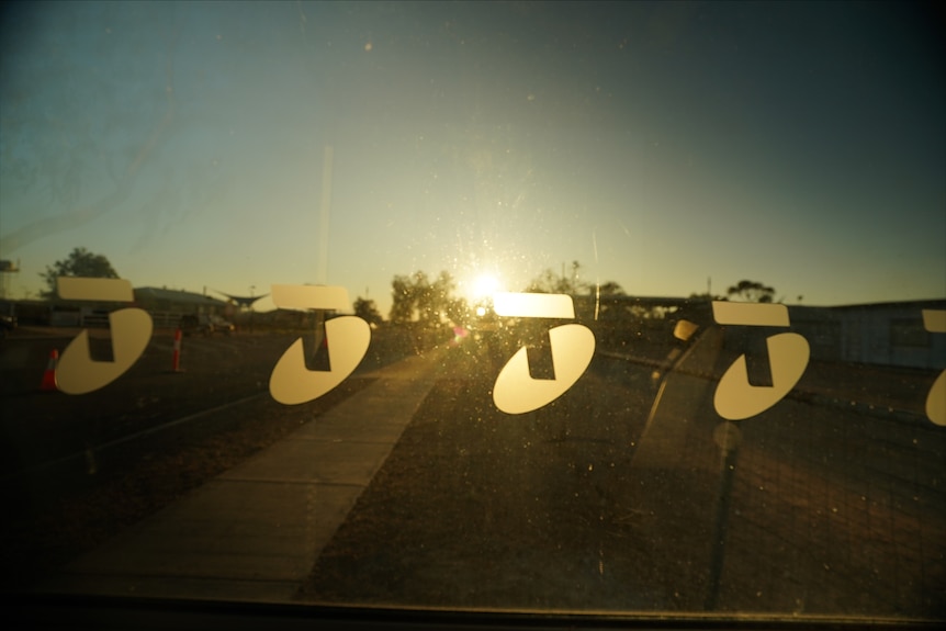 Shadow of Telstra phone box