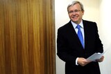 Kevin Rudd arrives at a press conference