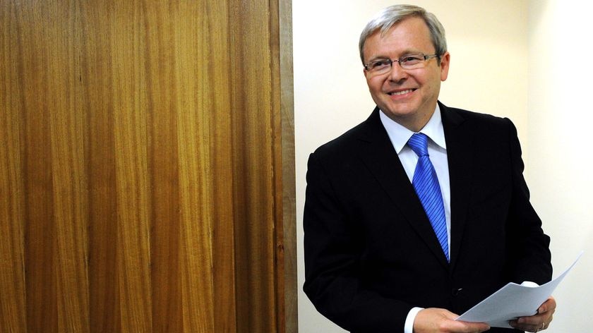 Kevin Rudd arrives at a press conference