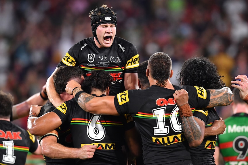 Rugby league team celebrate a victory