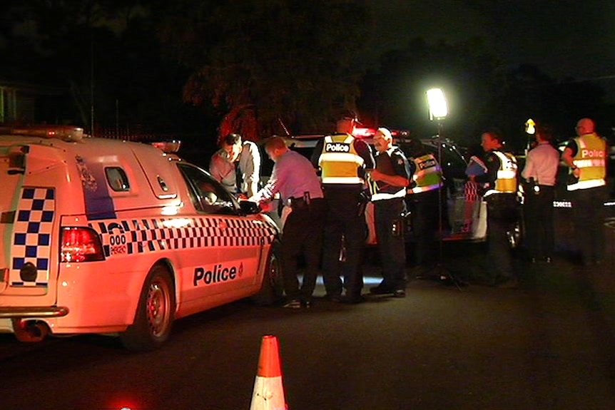 Police officers on a road.