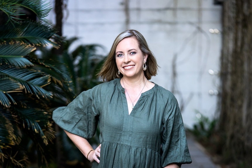 A lady wearing a green dress 