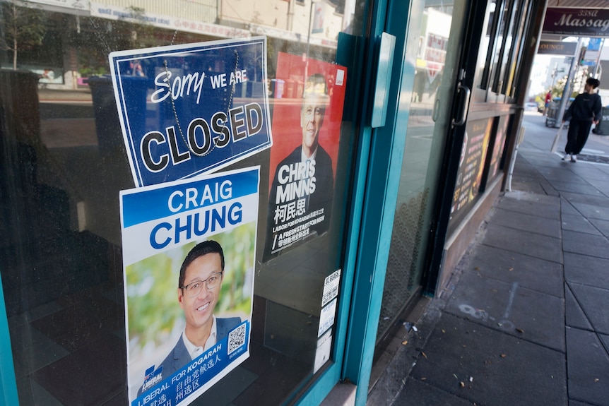 Posters of Chris Minns and Craig Chung stuck on glass door