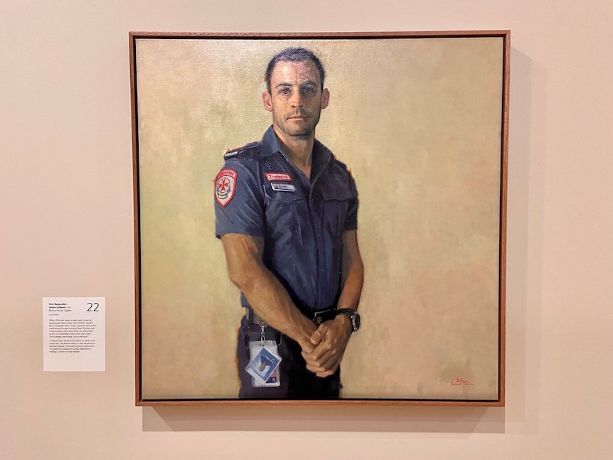 The painting is of a man in paramedic uniform standing with hands folded, looking directly at the viewer.