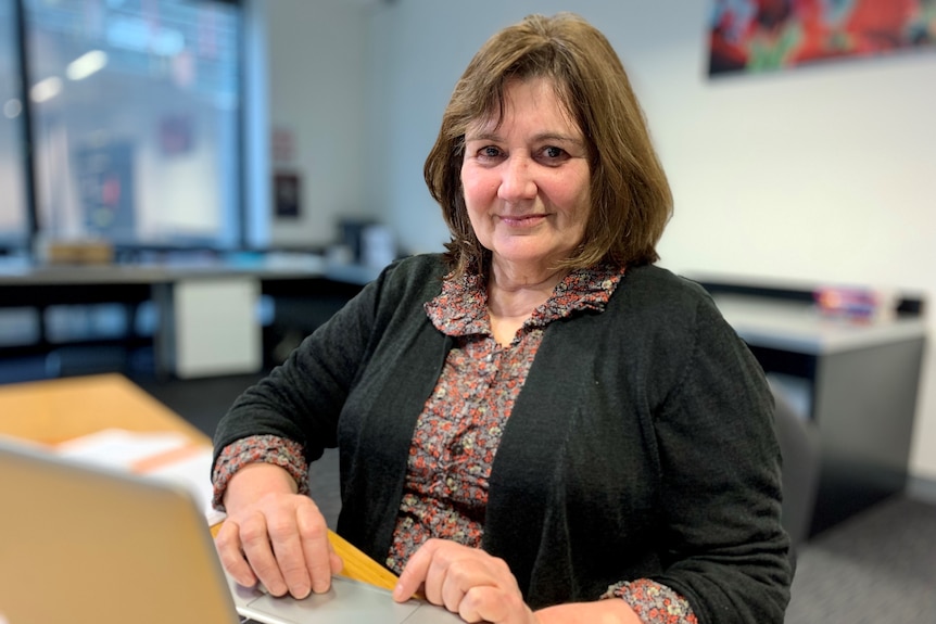 Fiona sitting at her desk at her Melbourne office in June 2022