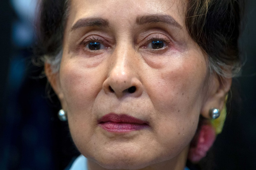 A woman of Asian descent is shown in a close up head shot