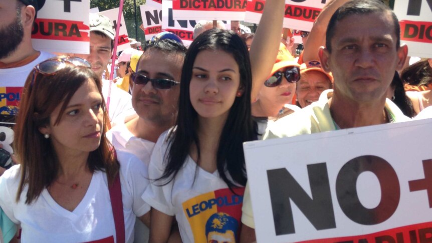 Protesters in Caracas hold placards and wear t-shirts with images of jailed Venezuelan opposition leader Leopoldo Lopez.