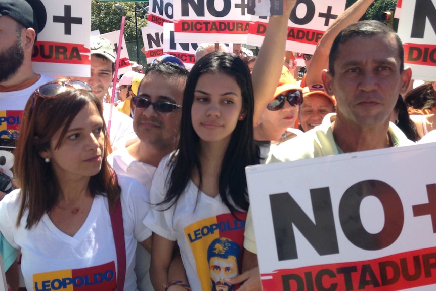 Protesters in Caracas hold placards and wear t-shirts with images of jailed Venezuelan opposition leader Leopoldo Lopez.