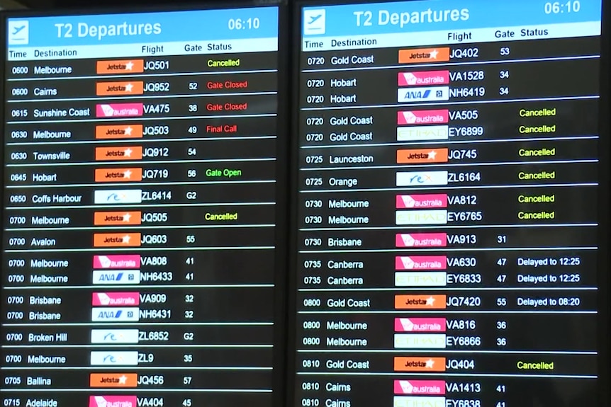 A board with airline logos and flight times listed