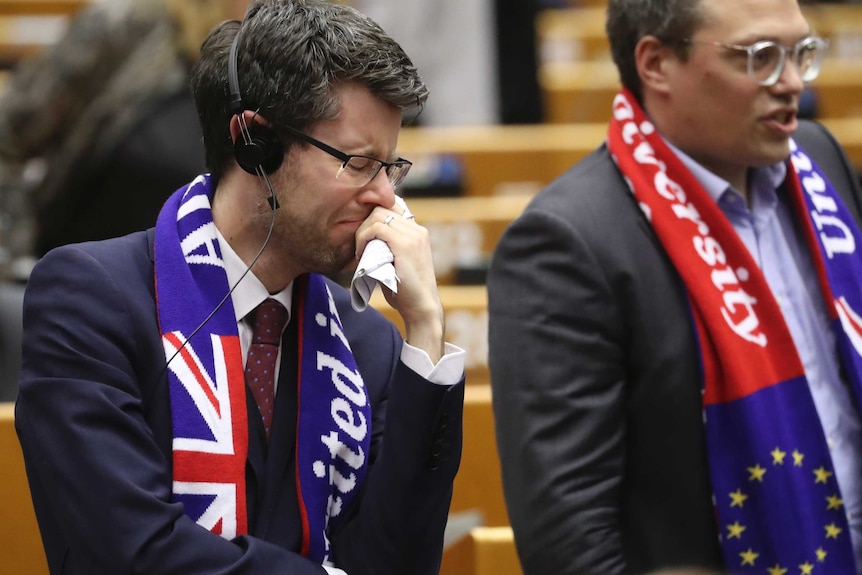 An MEP wearing a scarf looking emotional during the EU Parliament vote in Brussels.