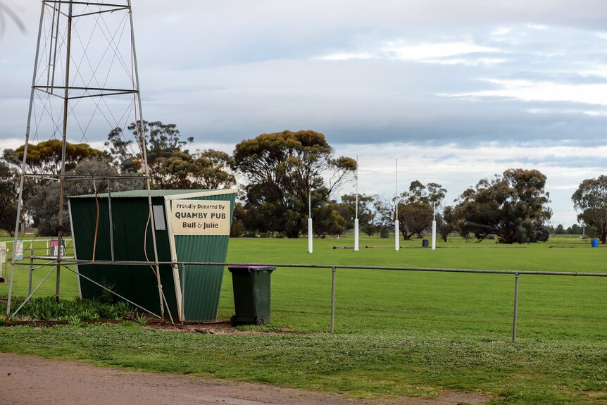 A country football ground with a tin shed on the side