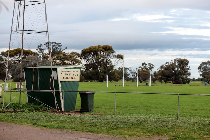 A country football ground with a tin shed on the side