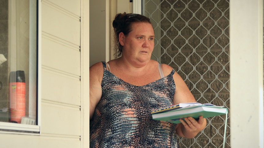 A woman at her front door.