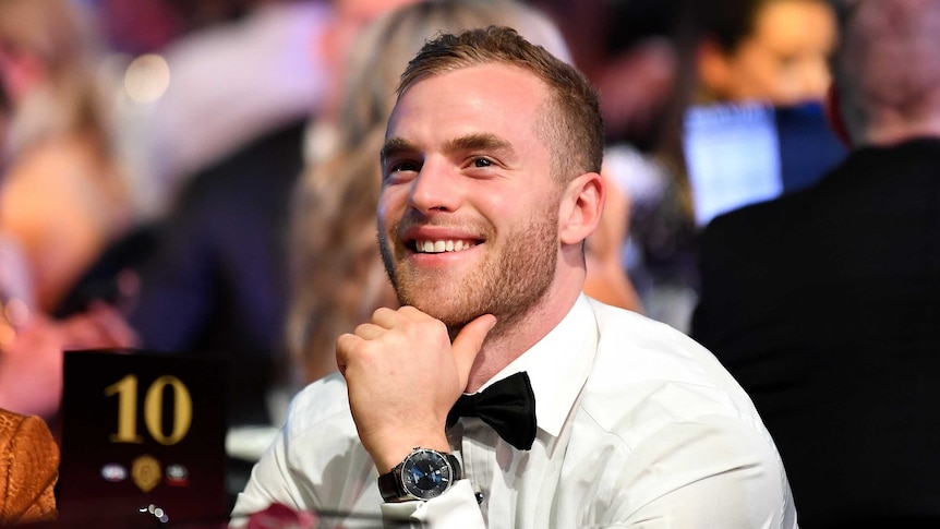 Tom Mitchell sitting at a table and smiling.