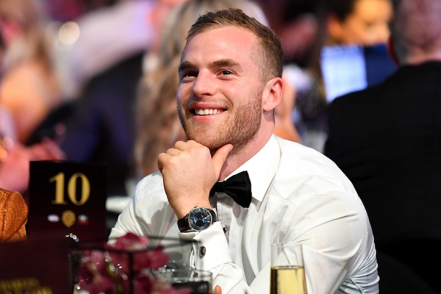 Tom Mitchell sitting at a table and smiling.