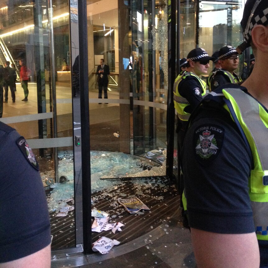 Glass door smashed as protesters clash with police