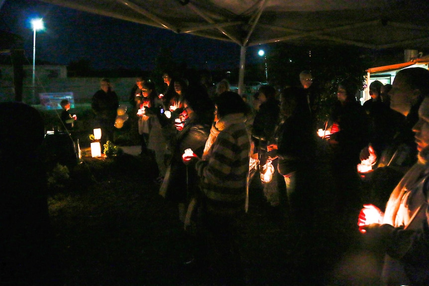 Family and friends of Jodi Eaton and Olga Neubert hold a vigil to protest against domestic violence.