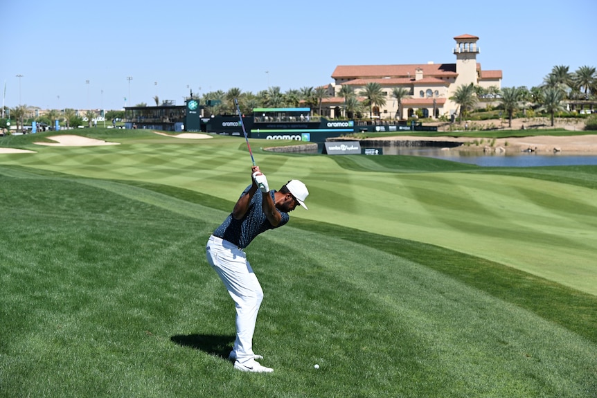 Tony Finau plays a shot towards the green from off the manicured fairway