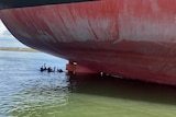 divers next to a ship