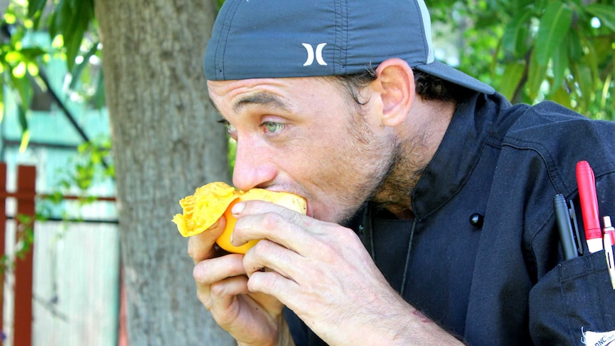Dwayne Masters eats a mango