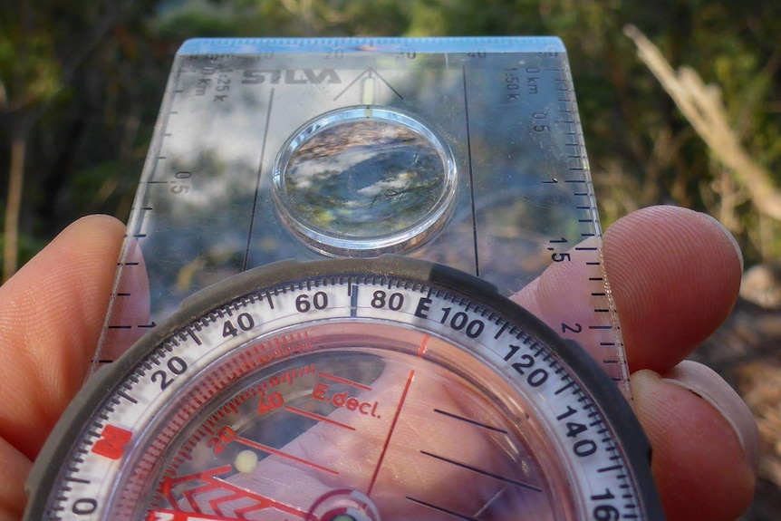 Compass held by bush search manager Caro Ryan