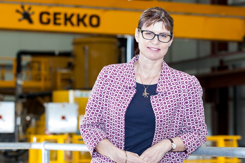 Elizabeth Lewis Gray, managing director of Gekko Systems, in front of an exhibition stand.