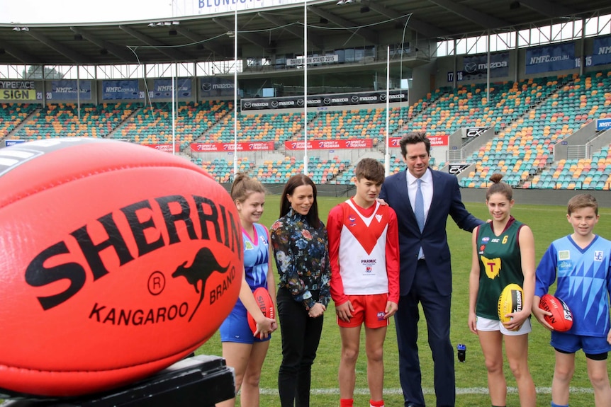 AFL CEO Gillon McLachlan with AFL Tasmania boss Trisha Squires with young players