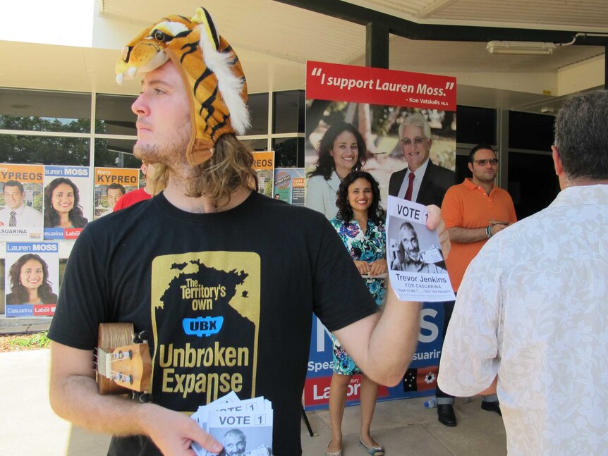 Matthew Haubrick hands out how-to-vote flyers for candidate Trevor Jenkins, watched by Labor's Lauren Moss.