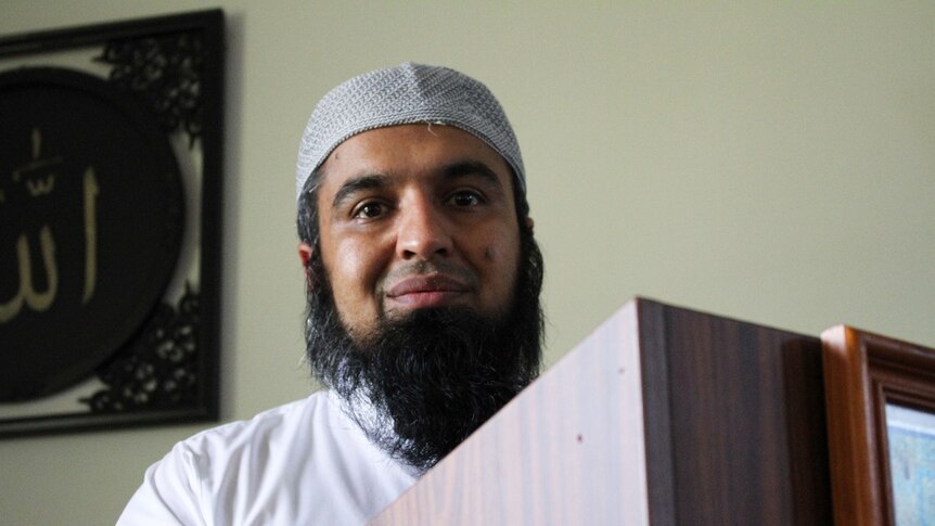 A photo of Dr Zia-ur Rehman speaking at a lectern in Cairns Mosque
