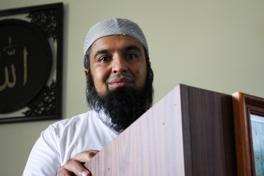 A photo of Dr Zia-ur Rehman speaking at a lectern in Cairns Mosque