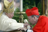 George Pell, pictured kissing the hand of Pope John Paul II on his appointment as a cardinal, says radical change is unlikely.
