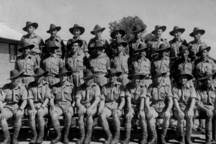 A group shot of Australian troops in slouch hats, shorts and boots.