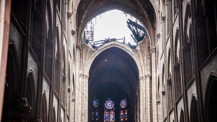 Sunlight streams in from a hole in the roof of the Notre Dame Cathedral