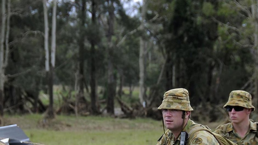 Soldiers search an area along Rocky Creek in Postmans Ridge, at the base of the Toowoomba range.