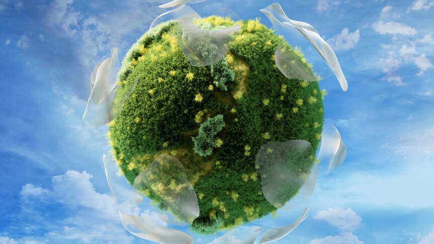 A green, grassy sphere on a sky background surrounded by clouds made of digital mesh