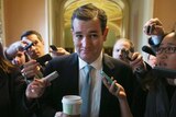 Senator Ted Cruz is trailed by reporters after a bipartisan deal was announced.