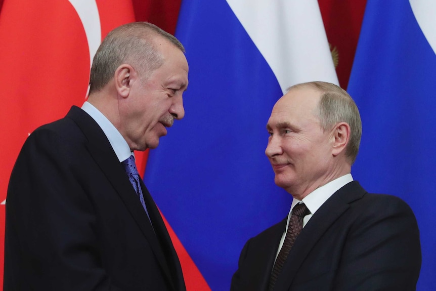 Russia's President Vladimir Putin and Turkish President Recep Tayyip Erdogan shake hands