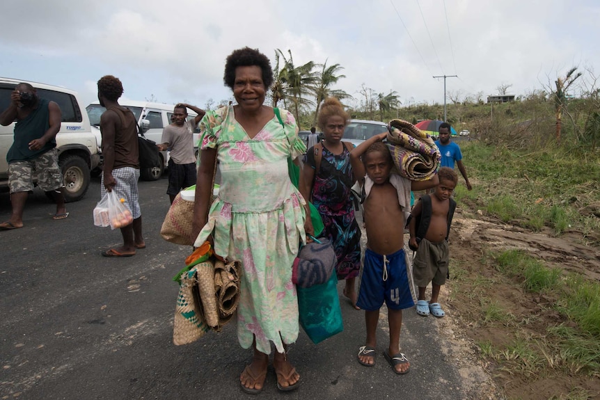 Locals carry their belongings in Vanuatu after Cyclone Pam