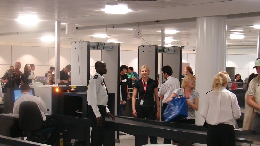 Passengers pass through an security screening check-point at Brisbane international airport