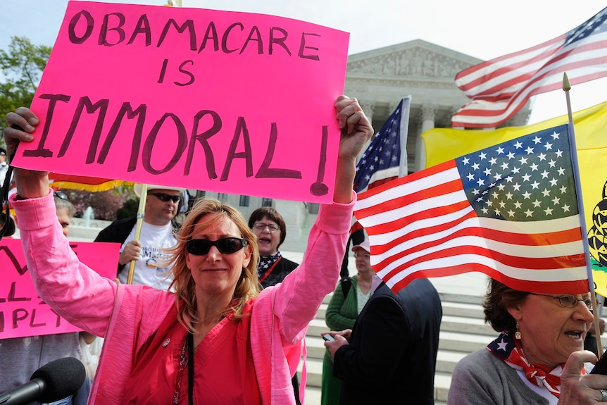 Opponents of US president Barack Obama's healthcare legislation rally outside the Supreme Court.