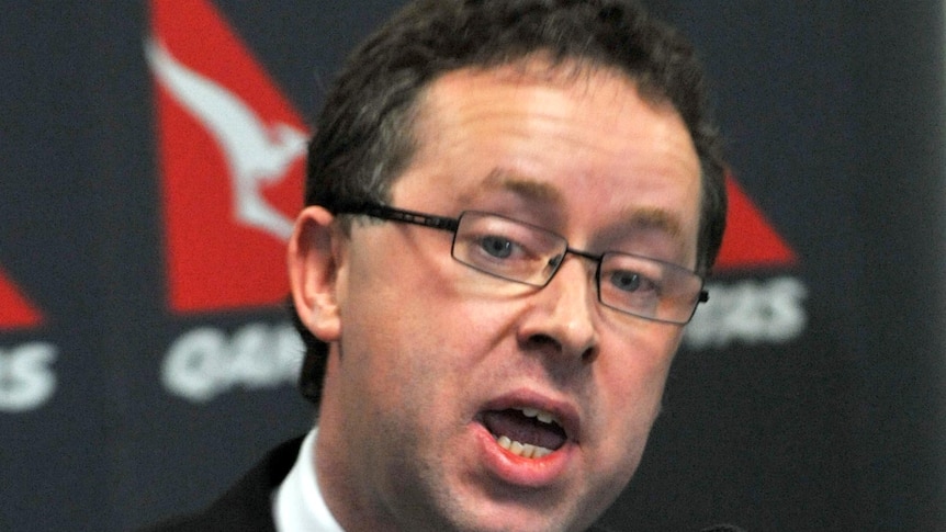 Qantas CEO Alan Joyce speaks to journalists during a media conference.