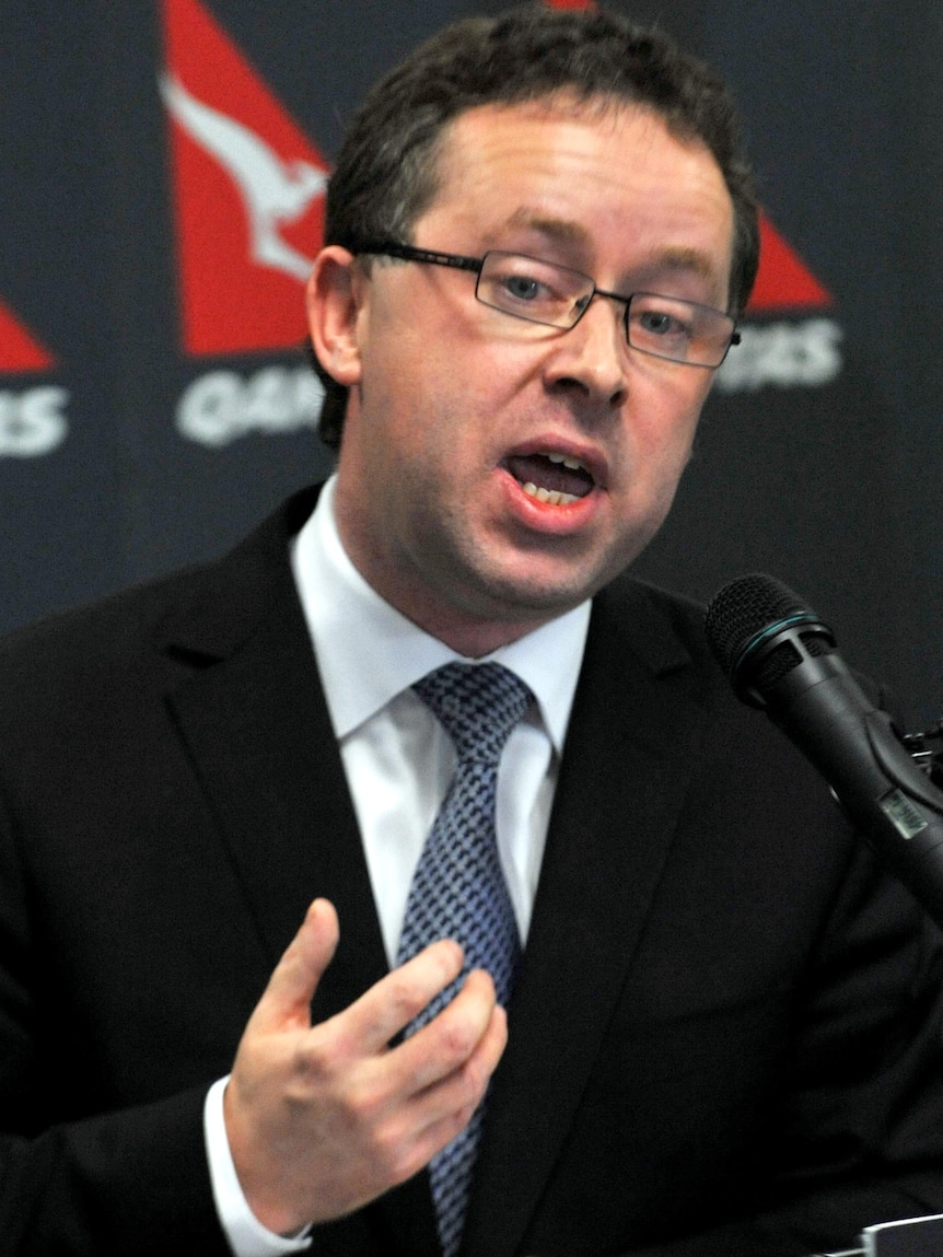 Qantas CEO Alan Joyce speaks to journalists during a media conference.