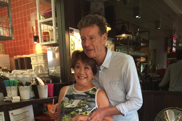 A woman and man stand in a restaurant