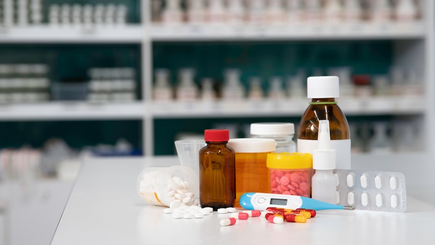 Placebos such as pills, tablets, and nasal spray are seen on the counter of a dispensary.