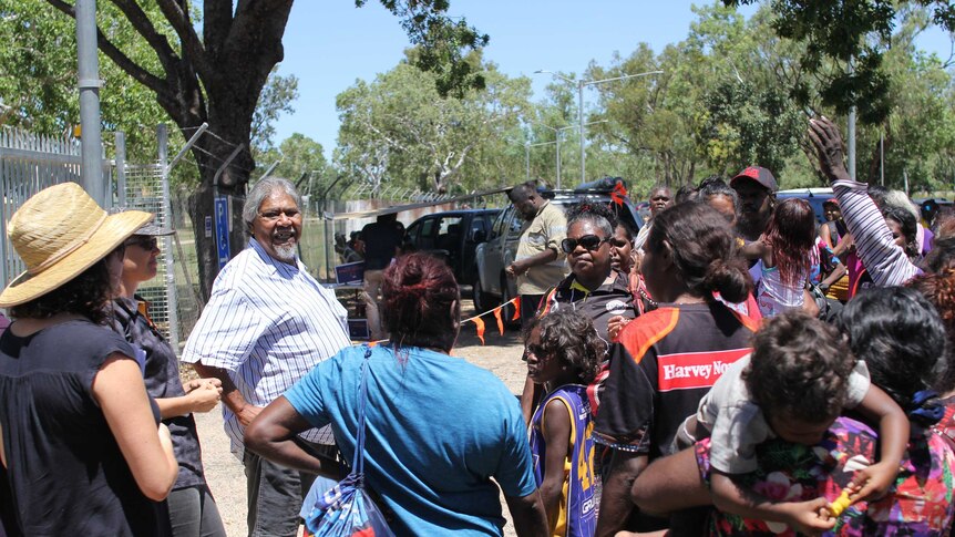 Members of the Jawoyn Association stand out front of a gate in Katherine.
